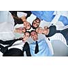 business people group joining hands and representing concept of friendship and teamwork,  low angle view