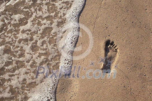 sand with footprint and water wave sand with footprint and water wave