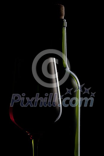 red wine in glass and bottle isolated on black red wine in glass and bottle isolated on black