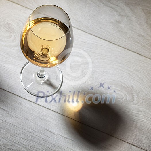 Glass of white wine on wooden table. Top view Glass of white wine on wooden table. Top view