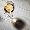 Glass of white wine on wooden table. Top view