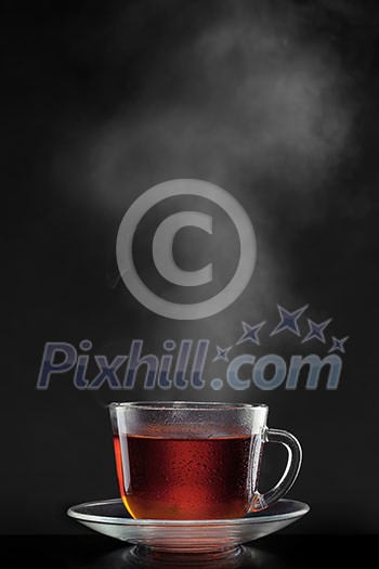 cup with hot tea and steam on black cup with hot tea and steam on black