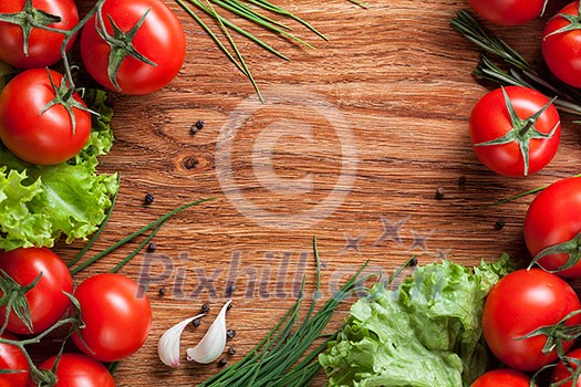red tomatoes with green salad on wood red tomatoes with green salad on wood