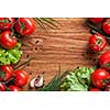 red tomatoes with green salad on wood