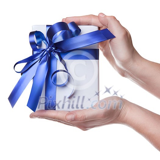 Hands holding gift in package with blue ribbon isolated on white Hands holding gift in package with blue ribbon isolated on white