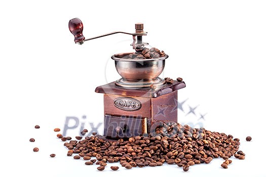 Retro manual coffee mill on roasted coffee beans isolated Retro manual coffee mill on roasted coffee beans isolated