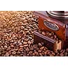 Retro manual coffee mill on roasted coffee beans