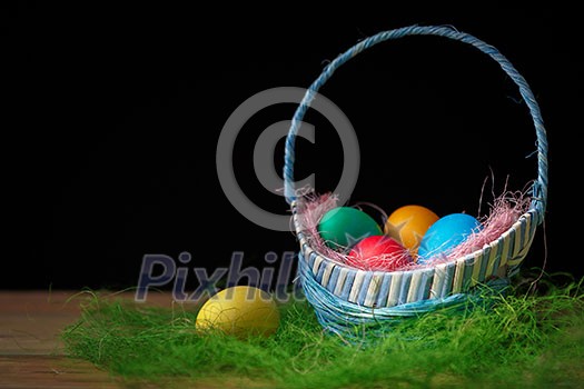 Easter eggs in the basket. Dark background. Easter eggs in the basket. Dark background.