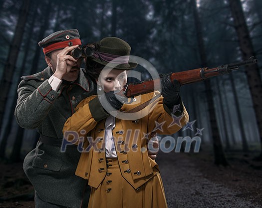 A German soldier with the lady on the hunt in the woods. A German soldier with the lady on the hunt in the woods.