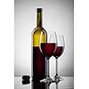 Wine in glasses and bottle on white