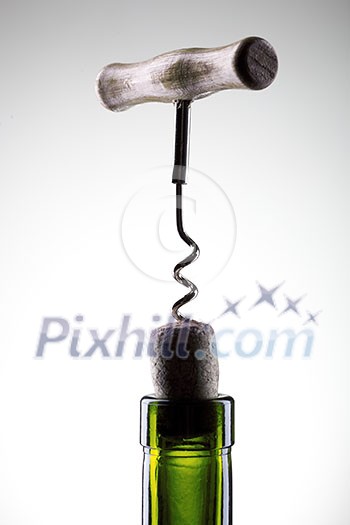 Corkscrew inserted into a wine fuse in a bottle on white Corkscrew inserted into a wine fuse in a bottle on white