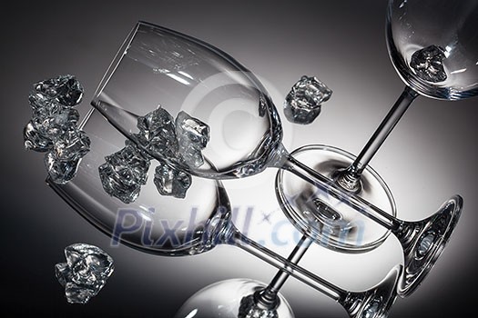 ice and empty wineglasses on color background ice and empty wineglasses on color background