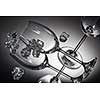 ice and empty wineglasses on color background