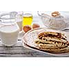 Close-up of crepes Stack and ingredients for cooking on a wooden table. Rustic style. Selected focus.