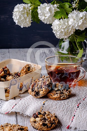 Cup of tea and cookies made of nuts and raisins. Kozinaki. Cup of tea and cookies made of nuts and raisins. Kozinaki.