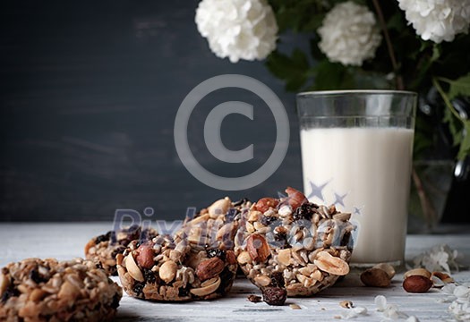 Glass of milk and cookies made of nuts and raisins. Kozinaki. Glass of milk and cookies made of nuts and raisins. Kozinaki.