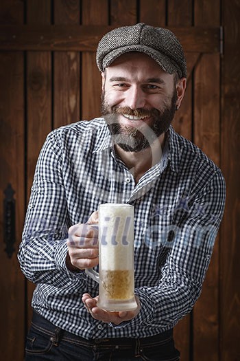 Happy man drinking beer from the mug. Happy man drinking beer from the mug.