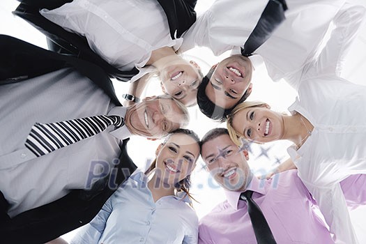 Closeup of happy business people with their heads together representing concept of ftiendship and teamwork isolated on white background Closeup of happy business people with their heads together representing concept of ftiendship and teamwork isolated on white background