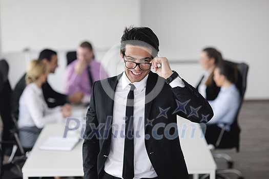 Confident young business man attending a meeting with his colleagues Confident young business man attending a meeting with his colleagues