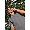 young happy  casual man talking on cellphone and writing sms message