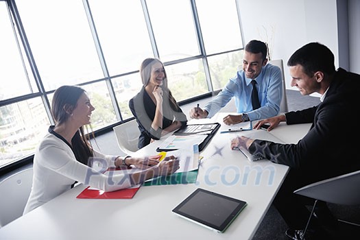 Group of happy young business people in a meeting at office Group of happy young business people in a meeting at office