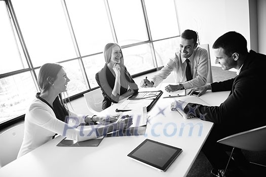 Group of happy young business people in a meeting at office Group of happy young business people in a meeting at office