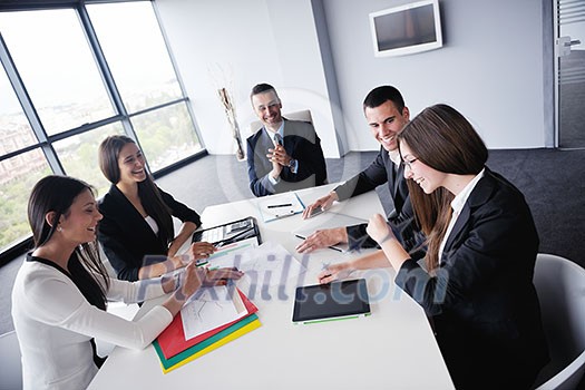 Group of happy young business people in a meeting at office Group of happy young business people in a meeting at office
