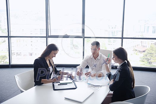 Group of happy young business people in a meeting at office Group of happy young business people in a meeting at office