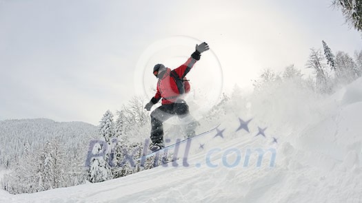 Snowboarder doing a jump and free ride on powder snow at winter season Snowboarder doing a jump and free ride on powder snow at winter season