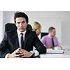Confident young business man attending a meeting with his colleagues