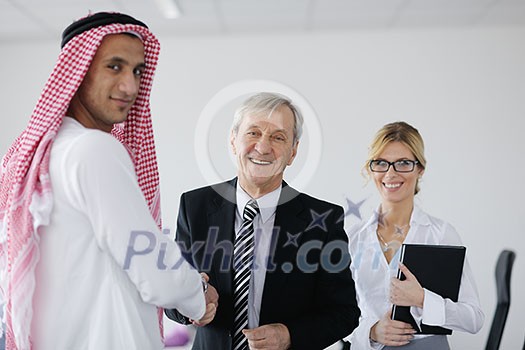 Business meeting - Handsome young Arabic man presenting his ideas to colleagues and listening for ideas for success investments at bright modern office room Business meeting - Handsome young Arabic man presenting his ideas to colleagues and listening for ideas for success investments at bright modern office room