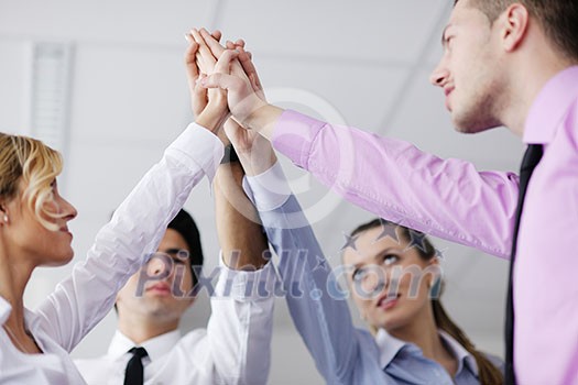 business people group joining hands and representing concept of friendship and teamwork, low angle view business people group joining hands and representing concept of friendship and teamwork, low angle view