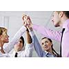 business people group joining hands and representing concept of friendship and teamwork,  low angle view