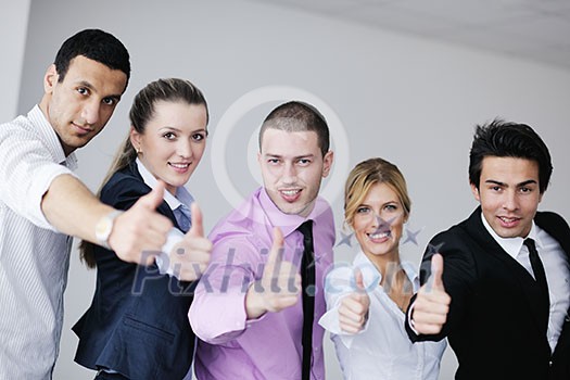 Group of young business people sitting in board room during meeting and discussing with paperwork Group of young business people sitting in board room during meeting and discussing with paperwork
