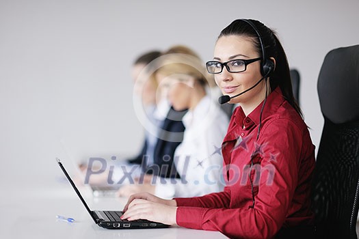 Pretty young business woman group with headphones smiling at you against white background Pretty young business woman group with headphones smiling at you against white background