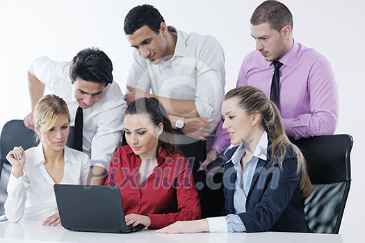 Group of young business people sitting in board room during meeting and discussing with paperwork Group of young business people sitting in board room during meeting and discussing with paperwork