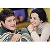 happy Young romantic couple and relaxing sofa in front of fireplace at winter season in home