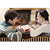 happy Young romantic couple and relaxing sofa in front of fireplace at winter season in home
