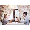 A young couple having dinner at a restaurant