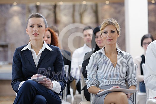 business woman standing with her staff in background at modern bright office conference room business woman standing with her staff in background at modern bright office conference room
