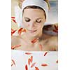 Beautiful young woman in spaand wellness. Face back and  stone massage