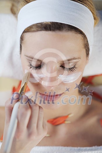 Beautiful young woman in spaand wellness. Face back and stone massage Beautiful young woman in spaand wellness. Face back and stone massage
