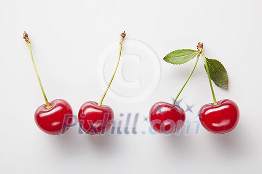Red cherry with leaves on white Red cherry with leaves on white