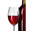Glass of red wine and bottle on stump isolated on white