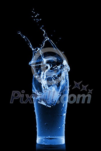 water splash in glass isolated on black water splash in glass isolated on black