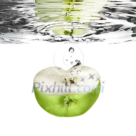 green apple dropped into water with bubbles isolated on white green apple dropped into water with bubbles isolated on white