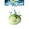 green apple dropped into water with bubbles isolated on white