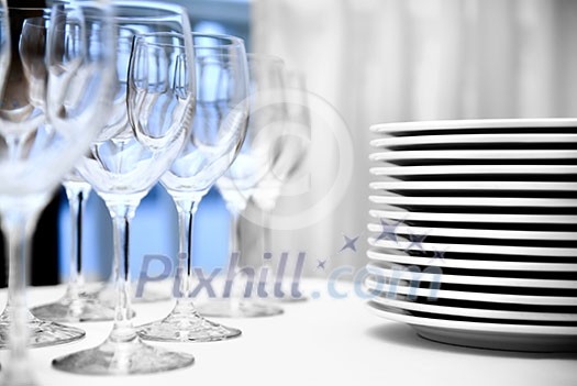 glass goblets and plates on the table glass goblets and plates on the table