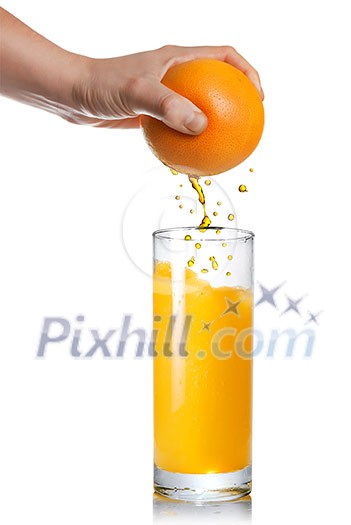 squeezing orange juice pouring into glass isolated on white squeezing orange juice pouring into glass isolated on white