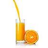 orange juice poring into glass isolated on white